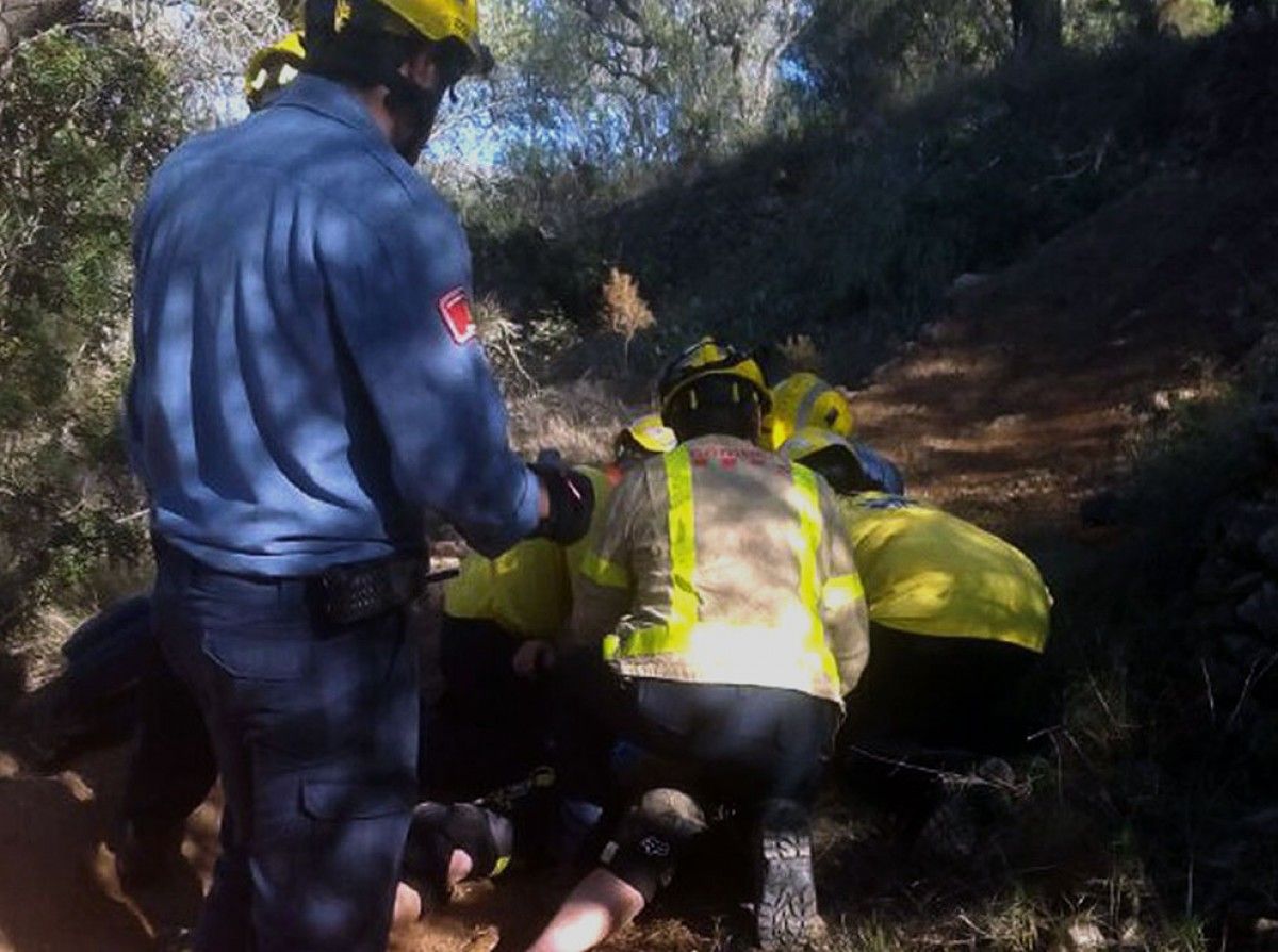 Els bombers han traslladat el ciclista ferit fins a l'ambulància, que no tenia accés a la pista.